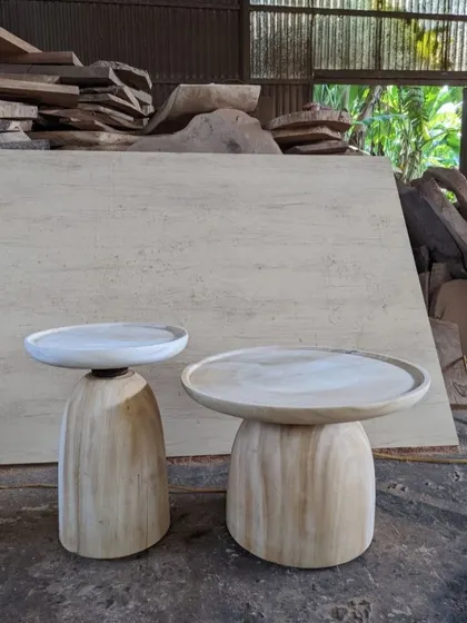 A pair of sculptural side tables in their raw, unfinished form. This shows the pure shape and beautiful grain of the wood before any finish is applied.