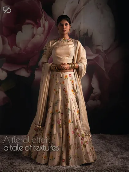 Inspired by nature’s symmetry, I bring you floral opulence. This lehenga is a cast of luxurious fabric wrapped in intricate floral wonder and sealed with elegant motifs.