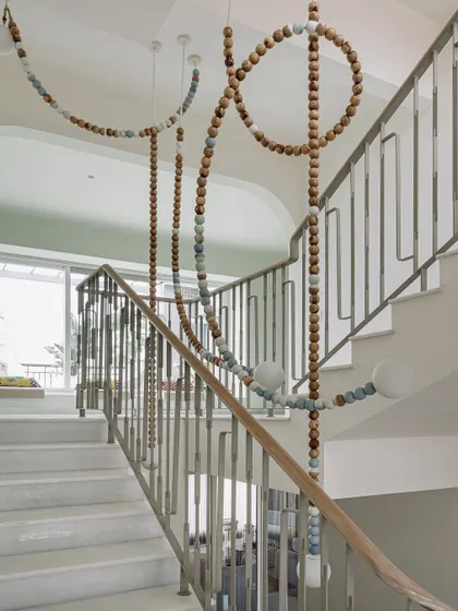 This is the 'Luna' light installation at Eden House, a piece we designed to be the soul of the stairwell. Crafted from wooden beads to depict the phases of the moon, it transforms a simple transitional space into a captivating artistic experience, blending form, function, and a touch of magic.