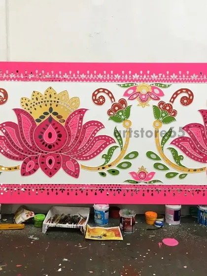 A finished section of a lotus-themed Lippan art panel, ready for installation. The combination of pink, green, and gold gives it a festive and traditional look.