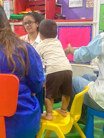 Full of curiosity and excitement, this little boy stands on his chair to get a better look. We encourage this natural inquisitiveness, as it's the engine of all learning and discovery.
