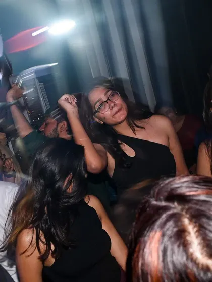 A motion-blurred shot of the crowd, capturing the chaotic energy of the dance floor.