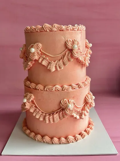 Introducing my mini two-tier cakes. This 800-gram vintage-style cake features intricate buttercream piping and ruffles, perfect for smaller, more intimate celebrations.