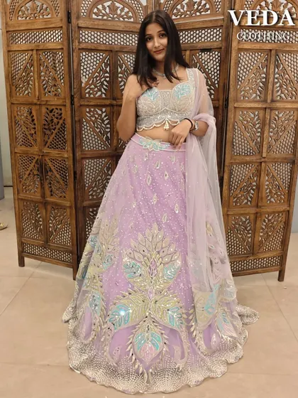 A full view of the whimsical lavender peacock lehenga. The colors are soft yet eye-catching.
