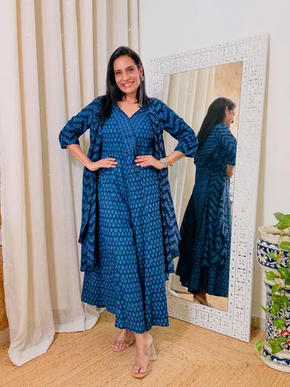 This indigo printed jumpsuit comes with a matching shrug, making it a very versatile three-piece set. You can wear them together or as separates.