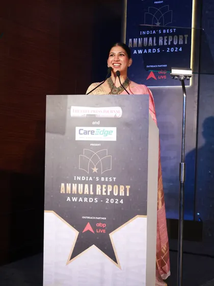 A full-length view of me at the podium for 'India's Best Annual Report Awards', setting a formal tone for the evening.