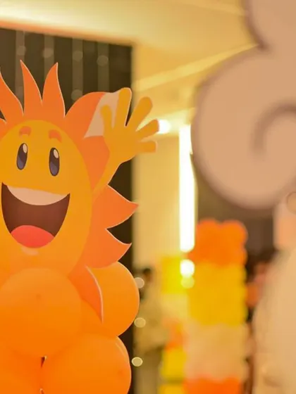 A cheerful, smiling sun character made from balloons adds a playful and friendly touch to the decor. These custom character props are always a hit with guests of all ages.