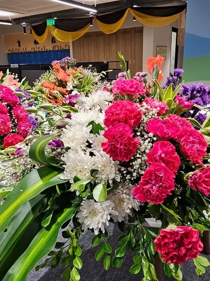 A close up of the vibrant floral arrangements used to decorate the interior of the UPS office for its opening ceremony. I use a mix of carnations, chrysanthemums, and fresh greens.