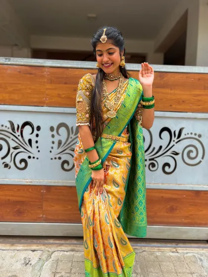 This is the kind of look I love creating for special occasions. This beautiful pure Kanchipuram silk saree in yellow with a contrasting green border and a heavily embroidered custom blouse is perfect for a bride's big day.