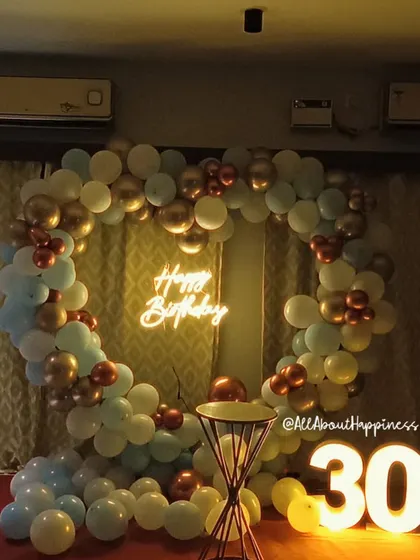 We are always creating new backdrops, like this stunning heart-shaped balloon arrangement in pastel blue, white, and gold for a 30th birthday.