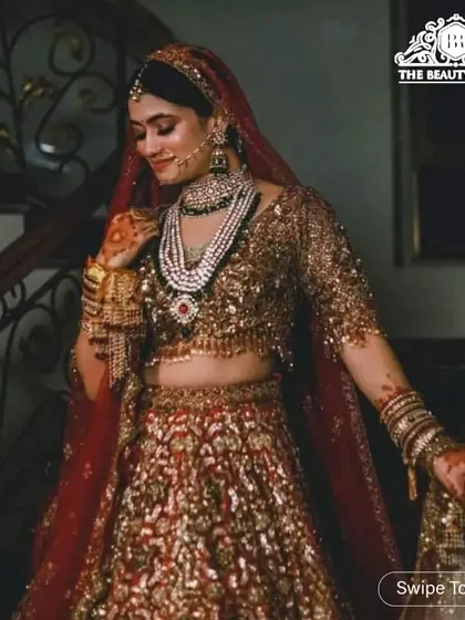 A stunning shot of the bride on a staircase, showcasing her magnificent lehenga and the flawless makeup that completes her royal look.