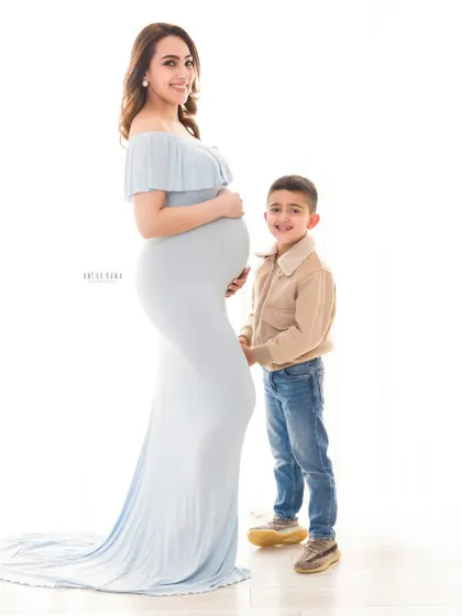 The journey to motherhood is a story of quiet strength and beautiful anticipation. Here, a mother-to-be shares a gentle moment with her son, a preview of the love that's about to multiply. This is a classic maternity portrait from my Gurgaon studio.