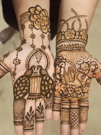 A modern and artistic take on traditional motifs. One hand features a peacock in a jharokha (window), while the other has a swan, offering a unique and creative mehndi style.