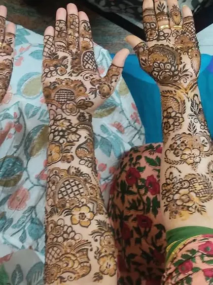 A beautiful shot of a bride and her bridesmaids, all with intricate, full-hand mehendi designs. I can create coordinated looks for the entire bridal party.