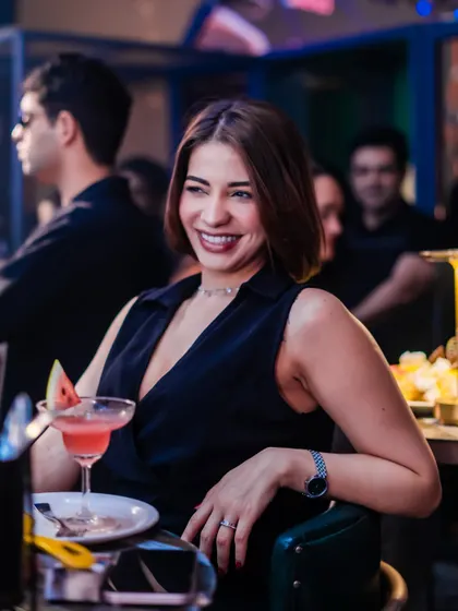 A guest enjoying a cocktail and the party vibes.