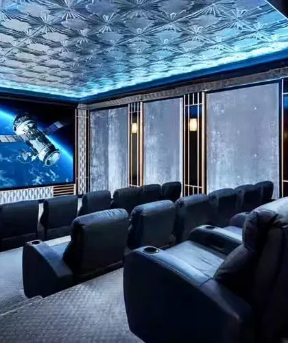 A space-themed home theater with a stunning ceiling that mimics a starry sky. The tiered seating ensures everyone gets a perfect view of the big screen.