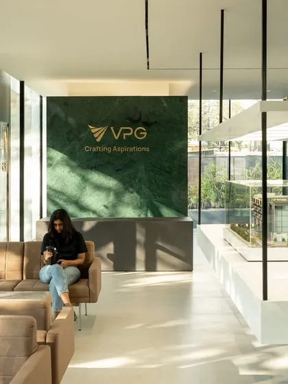 The interior of the VPG sales center, where a green marble feature wall provides a backdrop for the company's branding. The design is clean and functional, using natural light and an open layout to create a welcoming environment for customers.