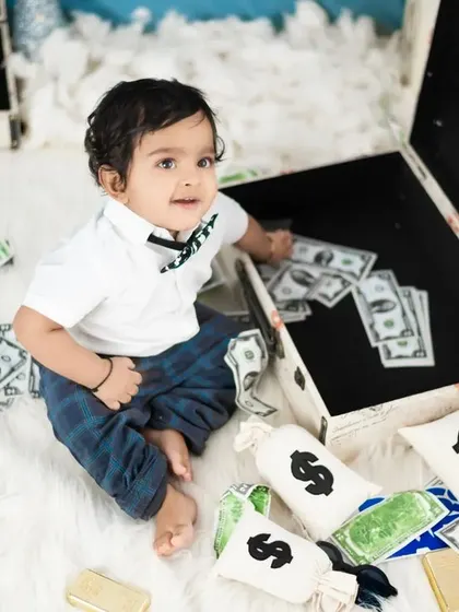 A playful moment from our Boss Baby theme, as the little one explores the suitcase full of cash.