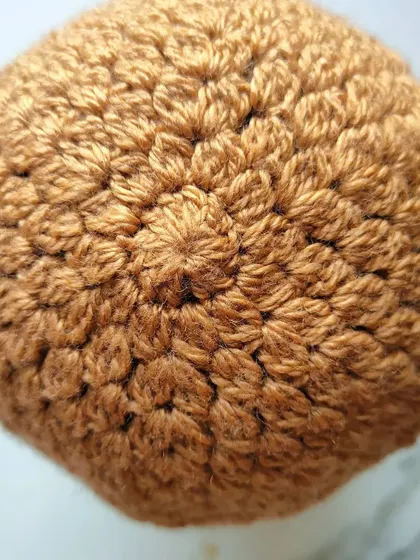 This view shows the top of the Flora beanie, where the cluster stitches radiate out from the center. It’s a simple but beautiful construction.