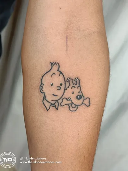 A nostalgic fine-line tattoo of Tintin and his dog, Snowy. This piece captures the essence of the beloved cartoon characters with clean, simple outlines, perfect for any fan of the classic adventure series.