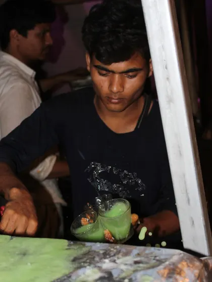 The action of pouring a fresh, cool drink for a guest. It's this kind of attentive service that defines the Rajdhani experience.