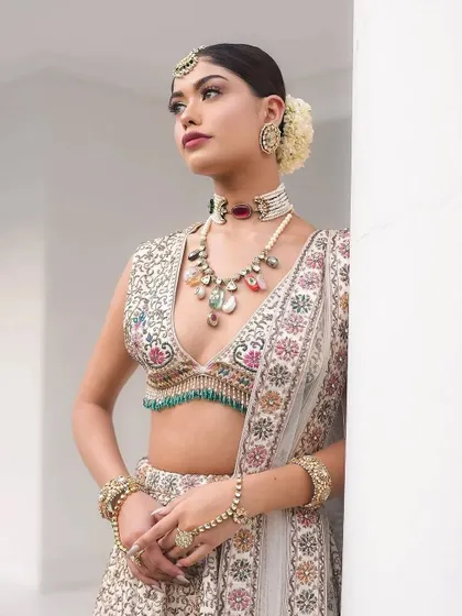 Presenting Laila, a dreamy bridal look. This ivory lehenga with multi-color floral embroidery is a work of art.