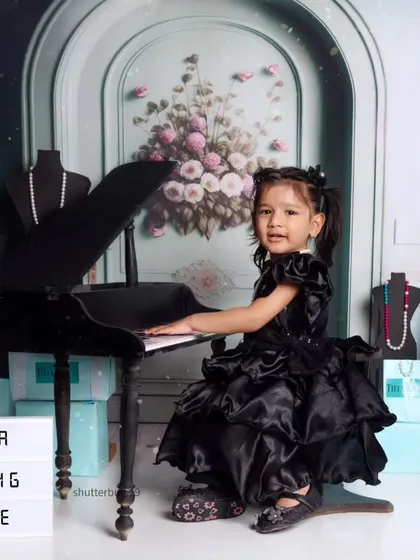 This little girl is ready for her piano recital in our "Breakfast at Tiffany's" inspired third birthday shoot.