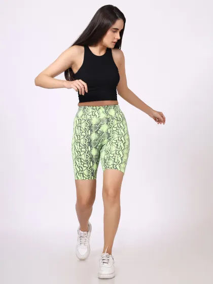 Another action shot of the model in the snakeskin shorts, providing a different angle of the outfit in motion.