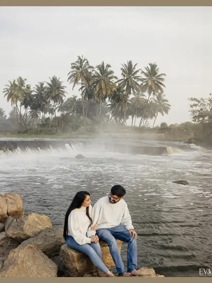 The couple shares a look amidst the beauty of a cascading waterfall. This shot captures the romance and tranquility of their pre-wedding session.
