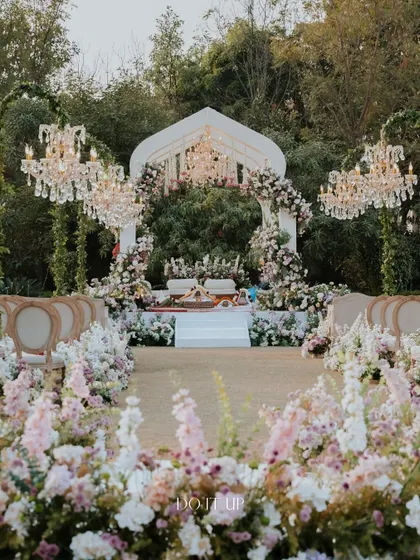 A wide view of the floral aisle and mandap from our Jaipur wedding. The design uses layers of flowers to create depth and texture, leading the eye towards the beautiful ceremony space.