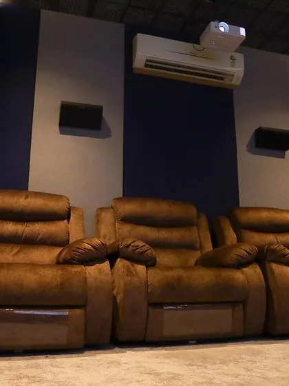 A duplicate of 327, this image provides another look at the comfortable, three-seater recliner setup.