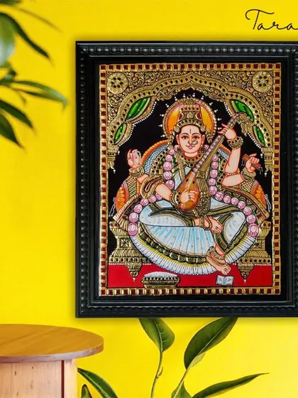 This serene Tanjore painting of Goddess Saraswati is perfect for creating a peaceful and inspiring atmosphere. The artwork is a beautiful reminder of the power of knowledge and creativity.