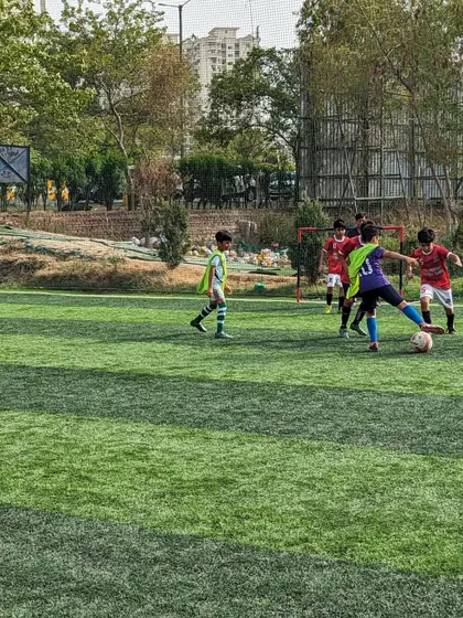 A moment of quick thinking as a player controls the ball under pressure from the opposition.