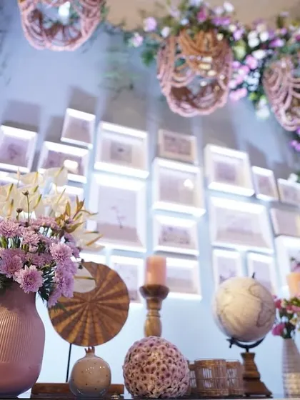 The 'daytime' section of our botanical-themed exhibition stall, featuring a gallery wall of pressed flowers, whimsical props, and light, airy florals.