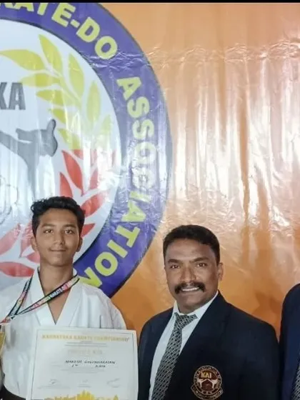 Celebrating Naresh's gold medal achievement at the Karnataka state level selections, pictured here with the coaching staff and officials.