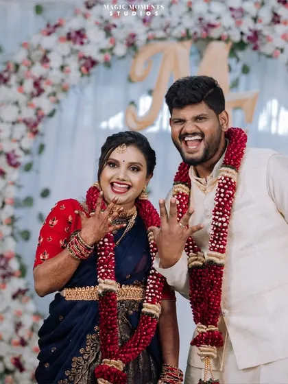The happy couple showing off their engagement rings. This is a classic shot that captures the excitement of the moment.