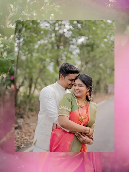 An artistic portrait of the couple embracing, framed with a soft pink border that complements the bride's saree.