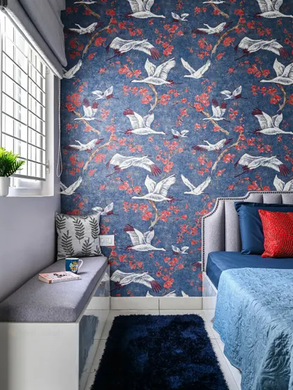 This view shows the cozy window seating area in the master bedroom, a perfect spot for relaxing. The deep blue rug complements the accent wall.