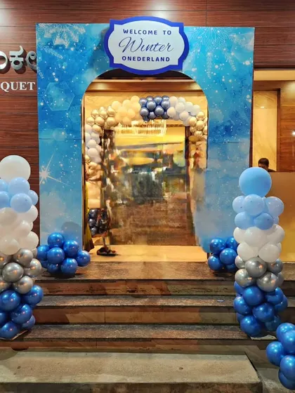 A grand entrance to a "Winter ONEDERLAND" party at a banquet hall, welcoming guests into a magical world from the very beginning.