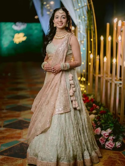A full-length portrait of the bride, Zaee, looking elegant in her Sangeet lehenga.