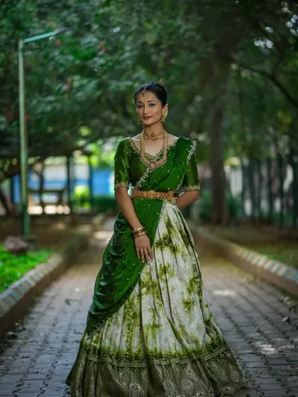 A client looking graceful in a green and white tie-dye style half saree for Navaratri Day 2.