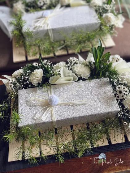 Quiet elegance is my signature. These made-to-order boxes, nestled in fresh white carnations and greenery, were crafted for a corporate thank you gift. They show how even bulk orders can feel deeply personal and sophisticated.
