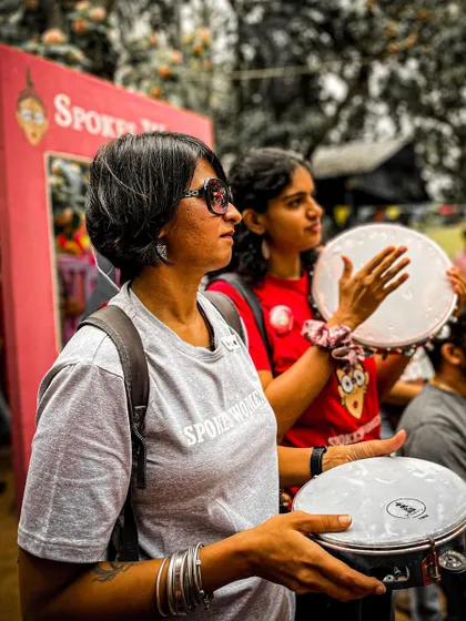 Members participating in the drum circle, creating a collective rhythm and a sense of unity.