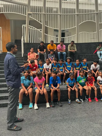 Mr. Gopichand interacting with a group of young, aspiring players, sharing his wisdom and experience in an informal session.