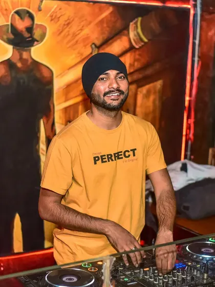A simple smile from the DJ booth. Being approachable and positive is key to creating a welcoming atmosphere in any club.