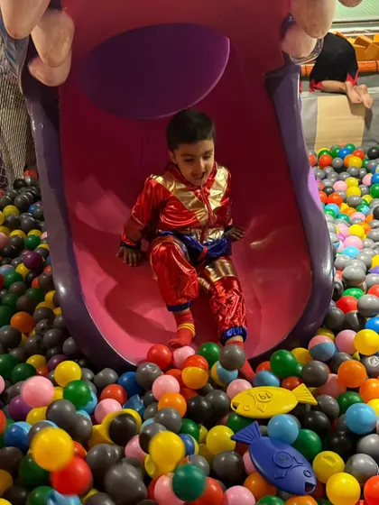 Another happy slider enjoying the ride into the colorful ball pit. The slide is always a main attraction.