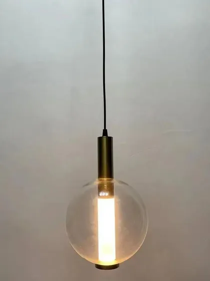 A minimalist hanging lamp featuring a clear glass globe with an internal tube light. This simple and modern design provides clean, bright light, making it a versatile choice for various contemporary settings.