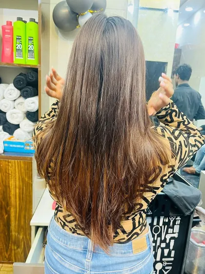 The back view of a feather cut on long hair, demonstrating how the layers create a light and airy feel.