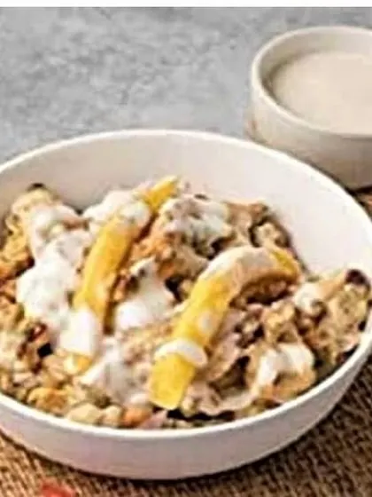 This is my shawarma bowl, a great option if you're looking for a lower-carb meal. It features all the shawarma chicken and toppings, including some fries, without the flatbread.