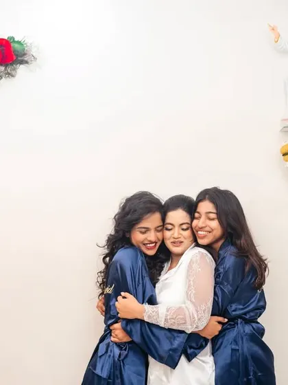 A sweet moment of friendship as the bride and her bridesmaids share a group hug.